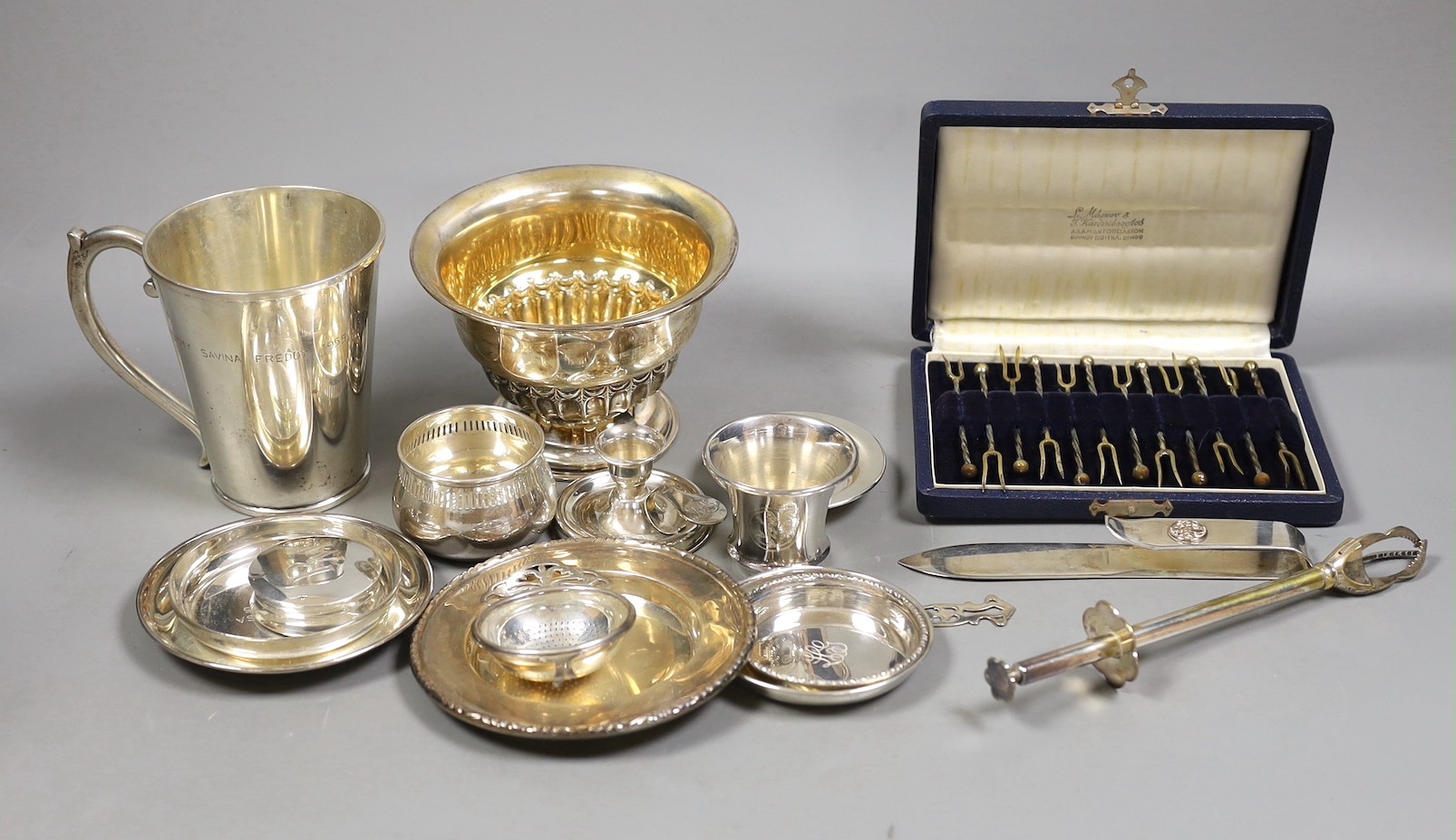 A late Victorian repousse silver pedestal bowl, Sheffield, 1898, diameter 12.8cm, three later silver dishes, a silver bowl, pill box and damaged tea strainer, eight Greek white metal items and a plated tongs.